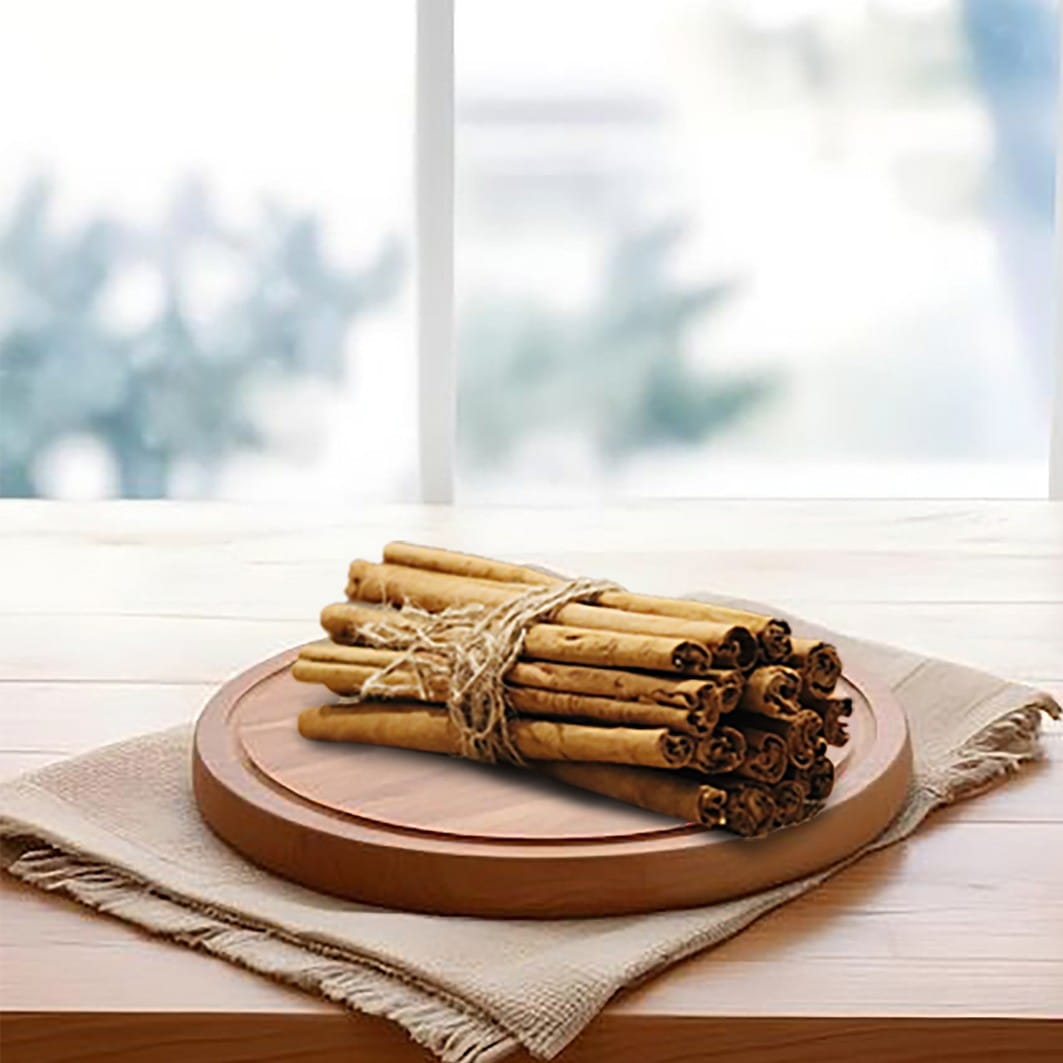 Cinnamon sticks arranged neatly on a rustic wooden cutting board, showcasing their rich brown color sold at Cey Cinnamon